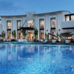 Spacious 4 BHK luxury villa for rent in Chennai featuring a large swimming pool, modern exterior, and premium residential setting.