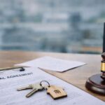 Rental agreement document with house keys and legal gavel representing rental laws and documentation in Chennai