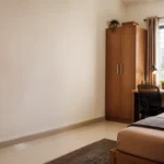 PG for rent in Chennai featuring a clean, fully furnished single room with study desk, wardrobe, and natural lighting.