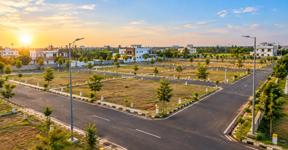 TNHB plots for sale in Chennai showing a modern residential layout with paved roads, marked plots, streetlights and homes